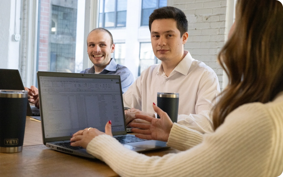 Colleagues reviewing a laptop together at a table