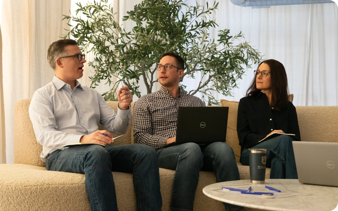 Physicians meeting with a consultant in an office lounge